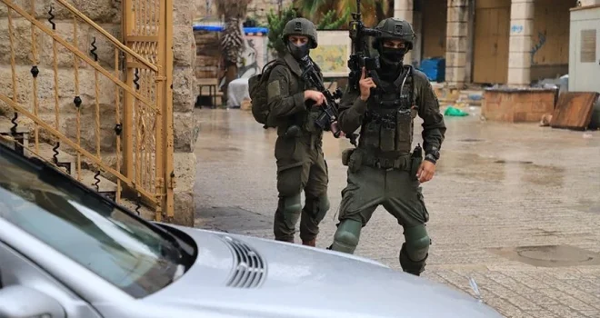 Israeli enemy arrest elderly man and child